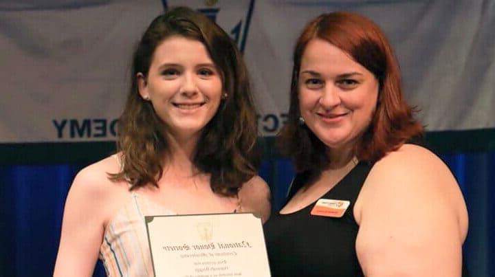 Hannah holding a National Honor Award