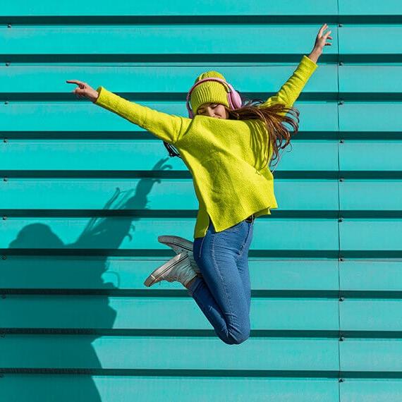 A teenage girl jumping in the air